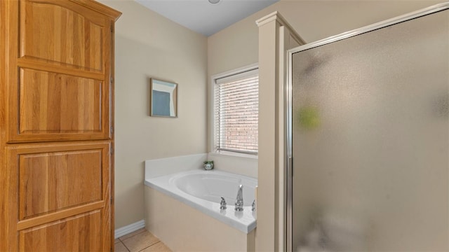 bathroom featuring tile patterned floors and shower with separate bathtub