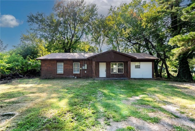 single story home with a front yard and brick siding