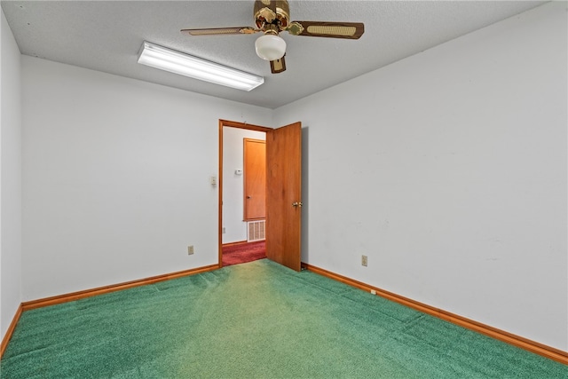 carpeted empty room with a textured ceiling and ceiling fan