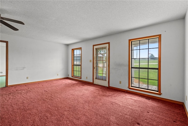 unfurnished room with ceiling fan, a textured ceiling, and carpet floors