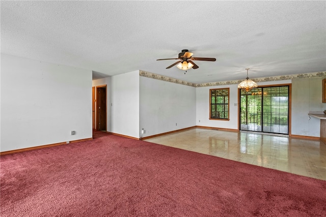 spare room featuring ceiling fan with notable chandelier, light colored carpet, and a textured ceiling