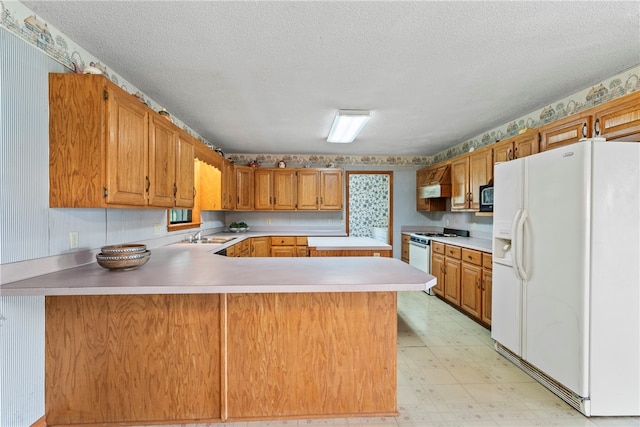 kitchen with a textured ceiling, kitchen peninsula, light tile patterned floors, and white appliances