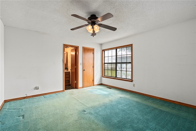 spare room featuring carpet flooring, ceiling fan, and a textured ceiling