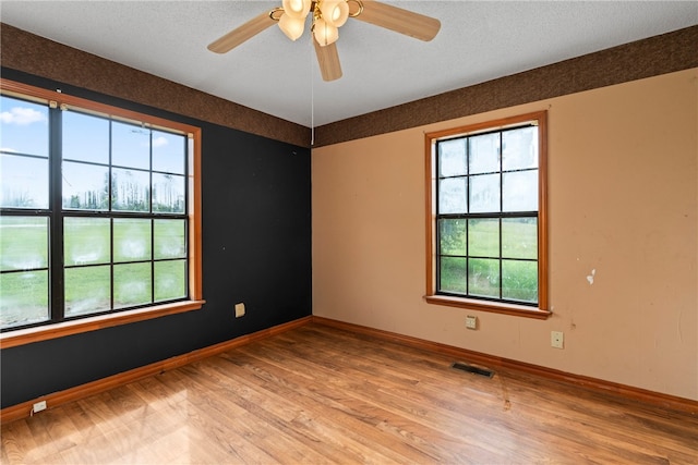 spare room featuring ceiling fan and hardwood / wood-style flooring