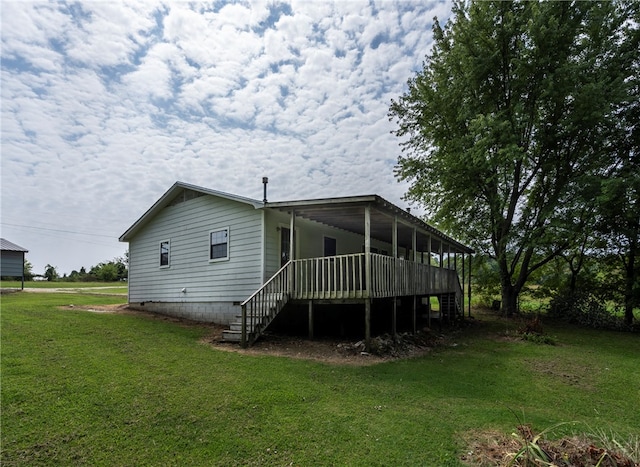 back of property featuring a lawn