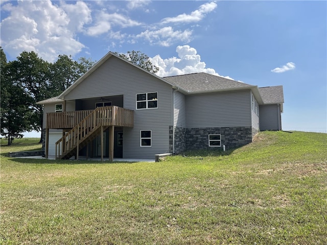 back of house with a lawn and a deck