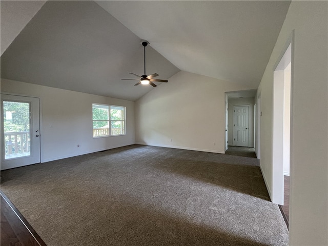 unfurnished living room featuring dark carpet, ceiling fan, and vaulted ceiling