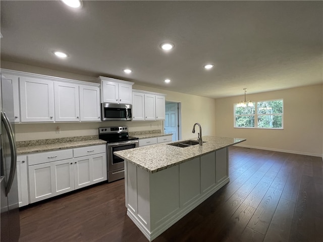 kitchen featuring white cabinets, stainless steel appliances, sink, and a center island with sink