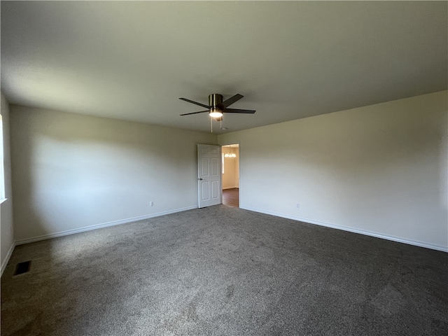 unfurnished room featuring ceiling fan and dark carpet