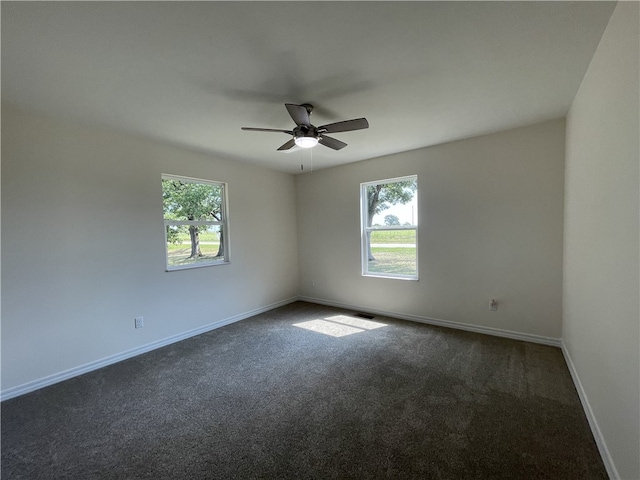 carpeted spare room with ceiling fan