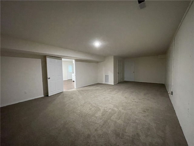 basement featuring dark carpet