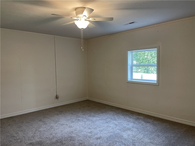 carpeted empty room with ceiling fan and ornamental molding