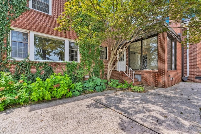 exterior space featuring brick siding