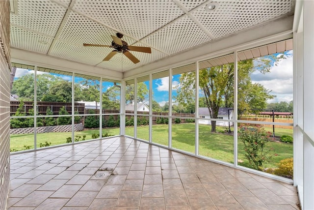 unfurnished sunroom featuring a ceiling fan