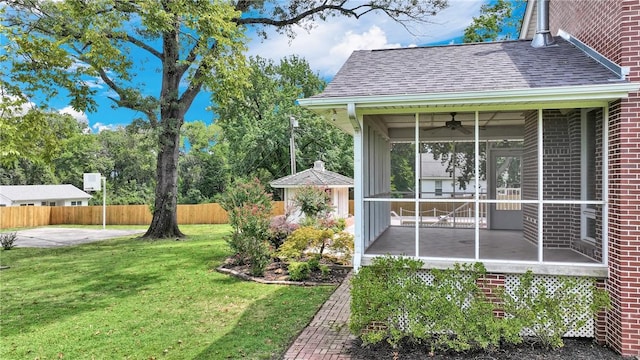 view of yard with fence and a sunroom