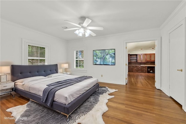 bedroom with baseboards, crown molding, ceiling fan, and wood finished floors