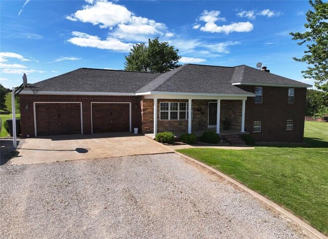 view of front of property with a garage and a front lawn