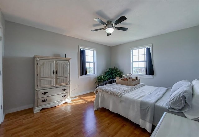 42 County Road 640, Green Forest, AR 72638 - bedroom with baseboards, wood finished floors, and a ceiling fan