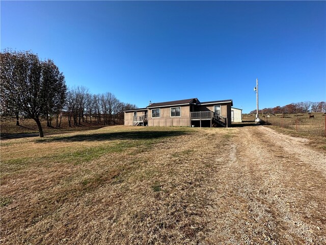 exterior space with a front lawn and a rural view