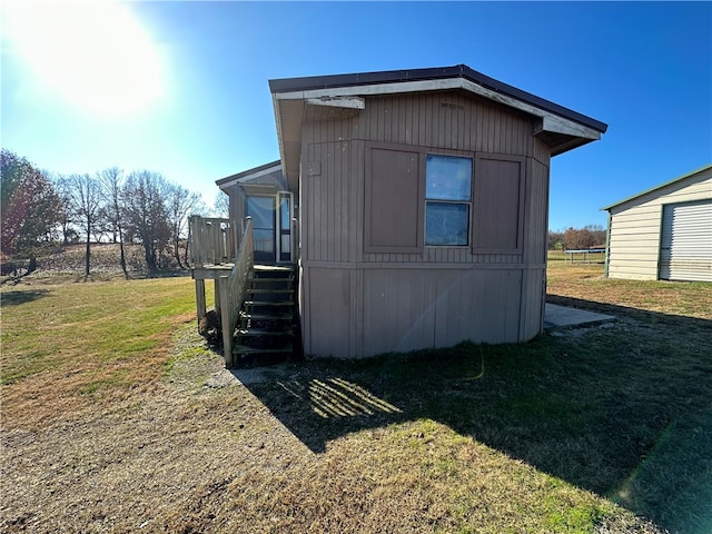 view of outbuilding with a lawn