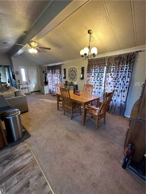 dining room with ceiling fan with notable chandelier, carpet floors, and vaulted ceiling with beams