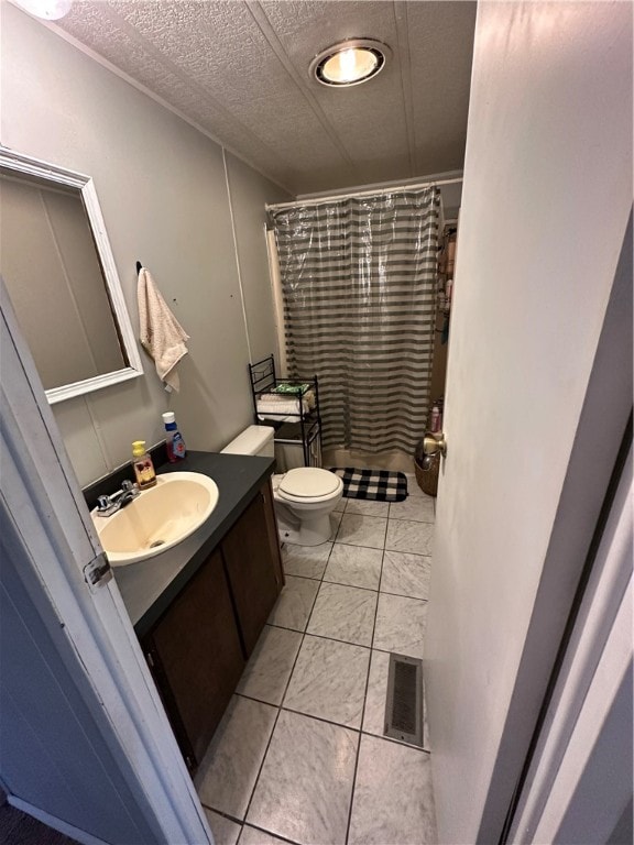 bathroom featuring vanity, toilet, a shower with curtain, and tile patterned floors