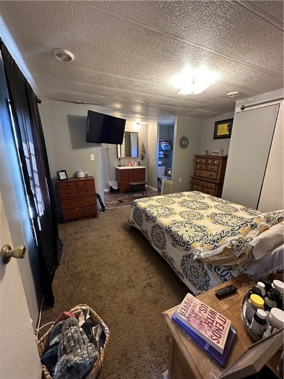 bedroom with a textured ceiling and carpet