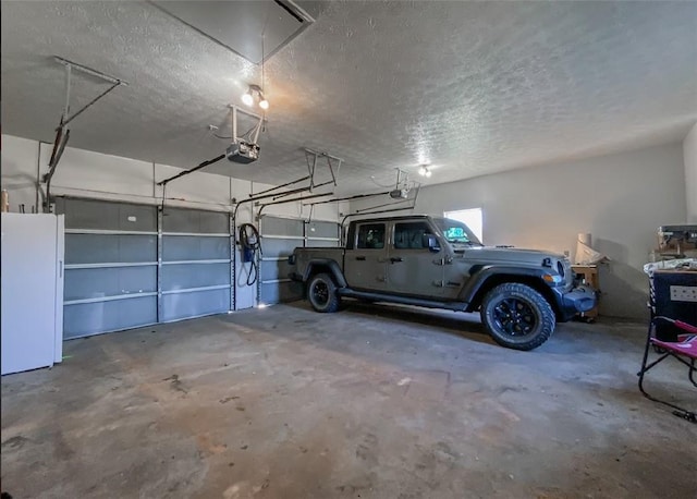 42 County Road 640, Green Forest, AR 72638 - garage featuring freestanding refrigerator and a garage door opener