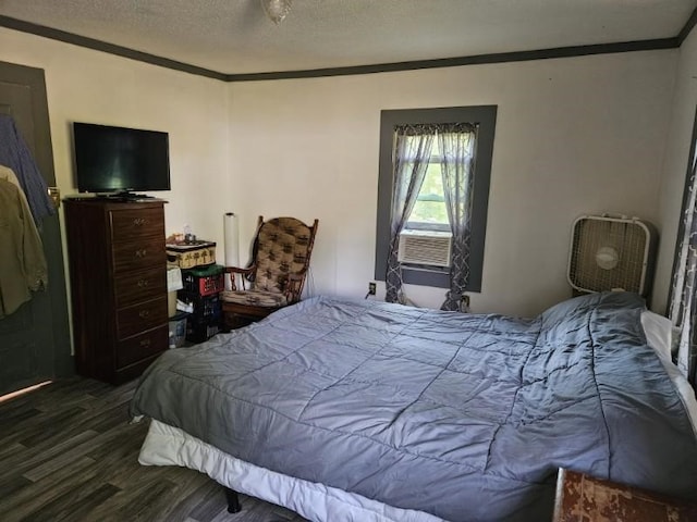 bedroom featuring wood-type flooring, a textured ceiling, cooling unit, and ornamental molding