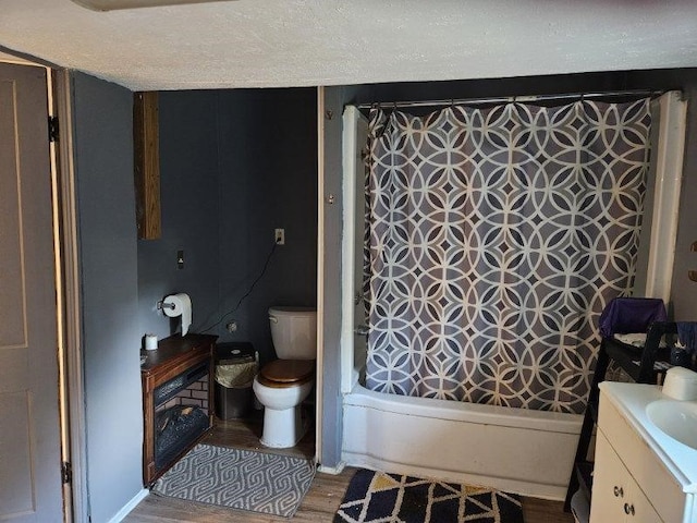 full bathroom featuring hardwood / wood-style flooring, vanity, toilet, and shower / tub combo with curtain