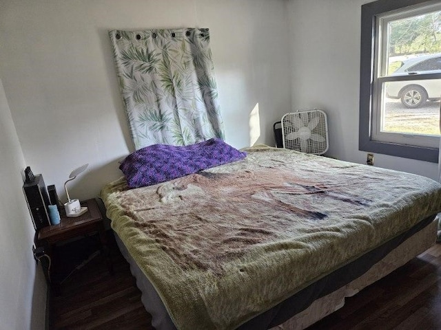 bedroom with dark wood-type flooring