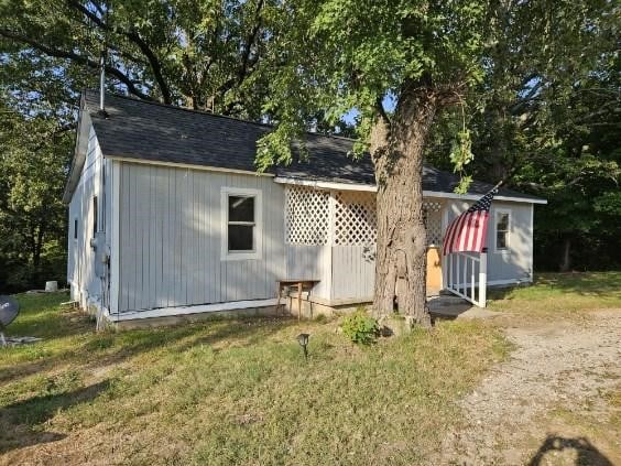 rear view of house featuring a yard