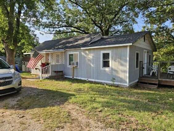 view of property exterior featuring a yard and a deck