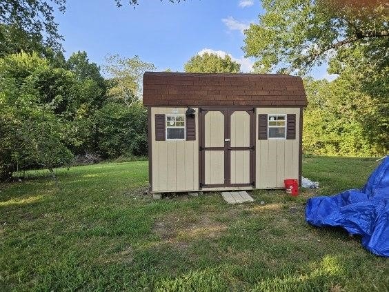 view of outbuilding featuring a lawn