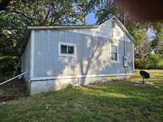 view of property exterior with a lawn