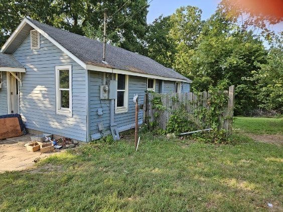 property exterior at dusk with a yard