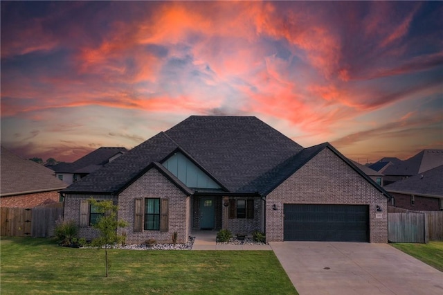 craftsman-style home featuring a garage and a yard