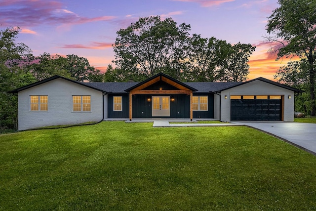 view of front of home with a lawn and a garage