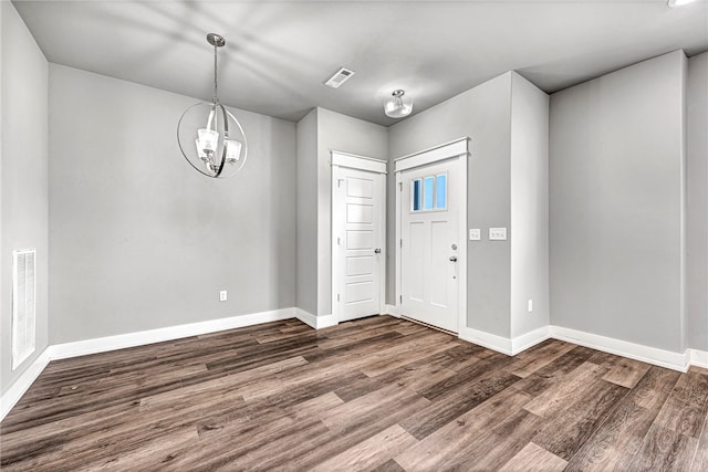 entryway featuring a notable chandelier and dark hardwood / wood-style floors