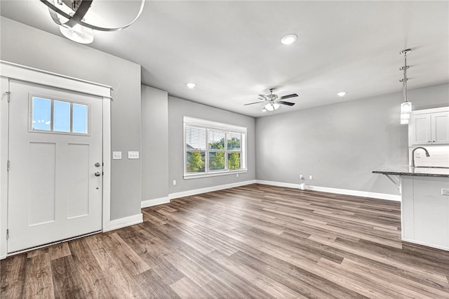 foyer entrance featuring ceiling fan and hardwood / wood-style flooring