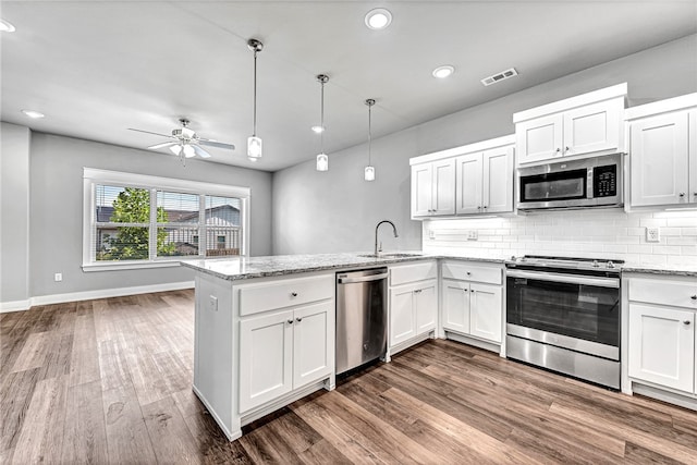 kitchen featuring sink, appliances with stainless steel finishes, and white cabinetry