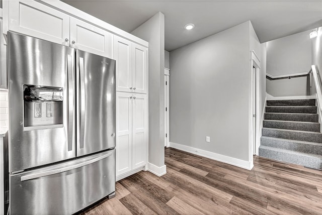 kitchen featuring stainless steel refrigerator with ice dispenser, white cabinets, and dark wood-type flooring