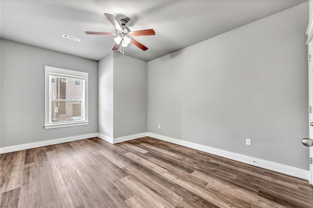 spare room with ceiling fan and hardwood / wood-style flooring