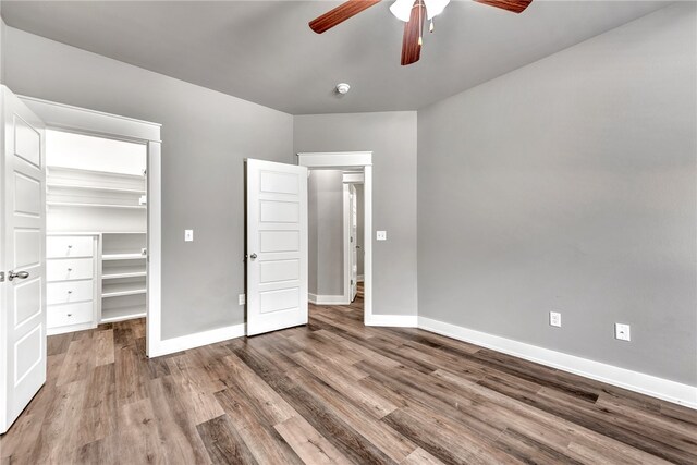 unfurnished bedroom with a closet, ceiling fan, and hardwood / wood-style flooring