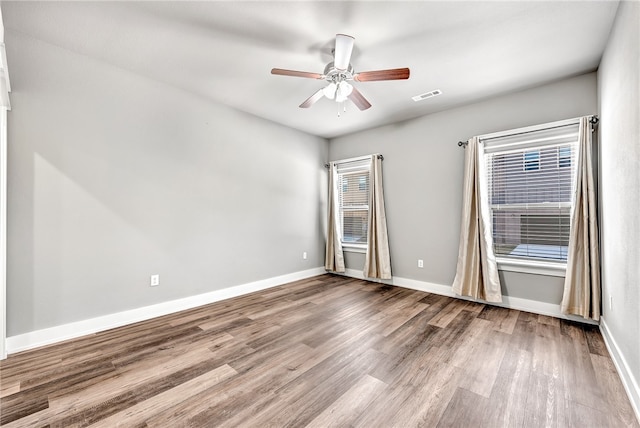 unfurnished room featuring hardwood / wood-style floors and ceiling fan