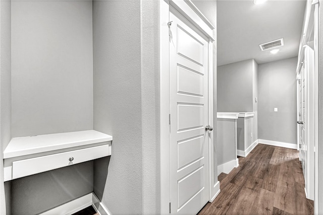 hall with dark hardwood / wood-style flooring