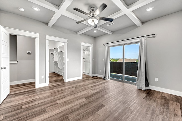 unfurnished bedroom with a spacious closet, ensuite bath, hardwood / wood-style floors, and ceiling fan