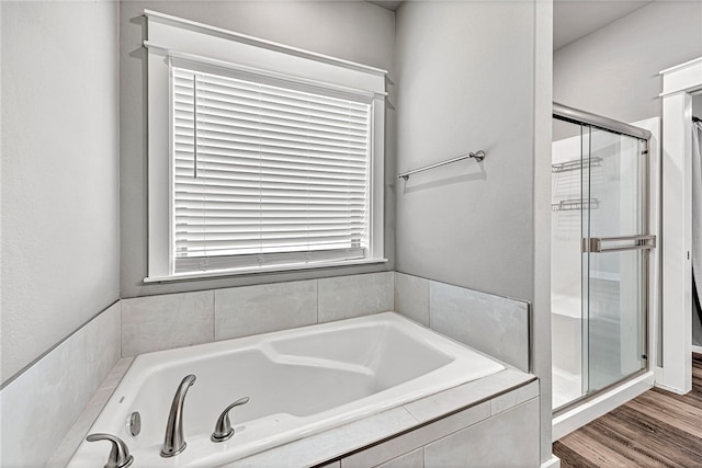 bathroom with separate shower and tub and hardwood / wood-style floors