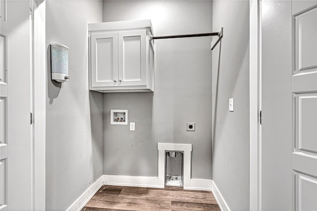 laundry room featuring hookup for an electric dryer, washer hookup, wood-type flooring, and cabinets