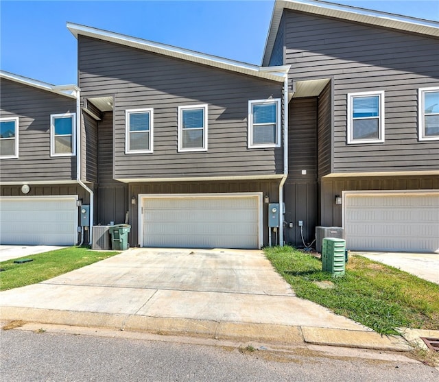 view of front of property featuring cooling unit and a garage